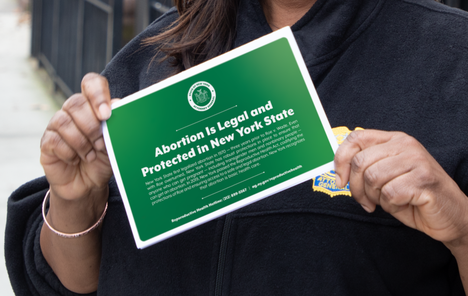 AG James holding a card about abortion rights