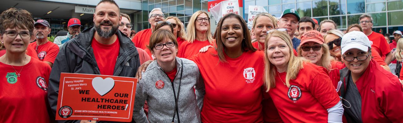 AG James with a group of health care workers