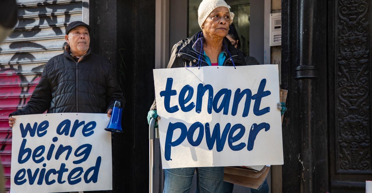 tenants with signs that read, We are Being Evicted and Tenant power